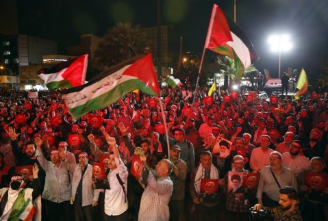 Iranian supporters of Hezbollah wave Palestinian flags in the Gaza Strip, in Tehran, Iran, 7 October 2023. (Photo: EPA-EFE / ABEDIN TAHERKENAREH)