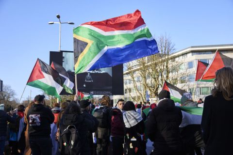 Pro-Palestinian protesters watch proceedings outside the International Court of Justice during the court ruling in The Hague, Netherlands, on Friday, Jan. 26, 2024. At the end of December, South Africa accused Israel in the International Court of Justice of committing genocide in Gaza, a charge vigorously denied by the Israeli government. Photographer: Ksenia Kuleshova/Bloomberg via Getty Images